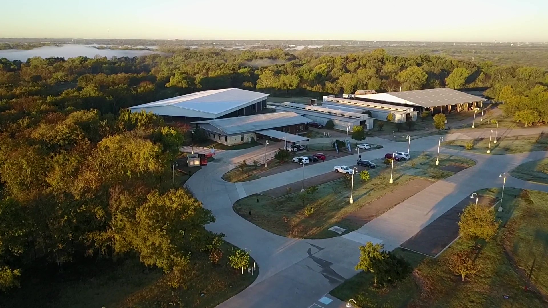 an aerial view of a building surrounded by trees