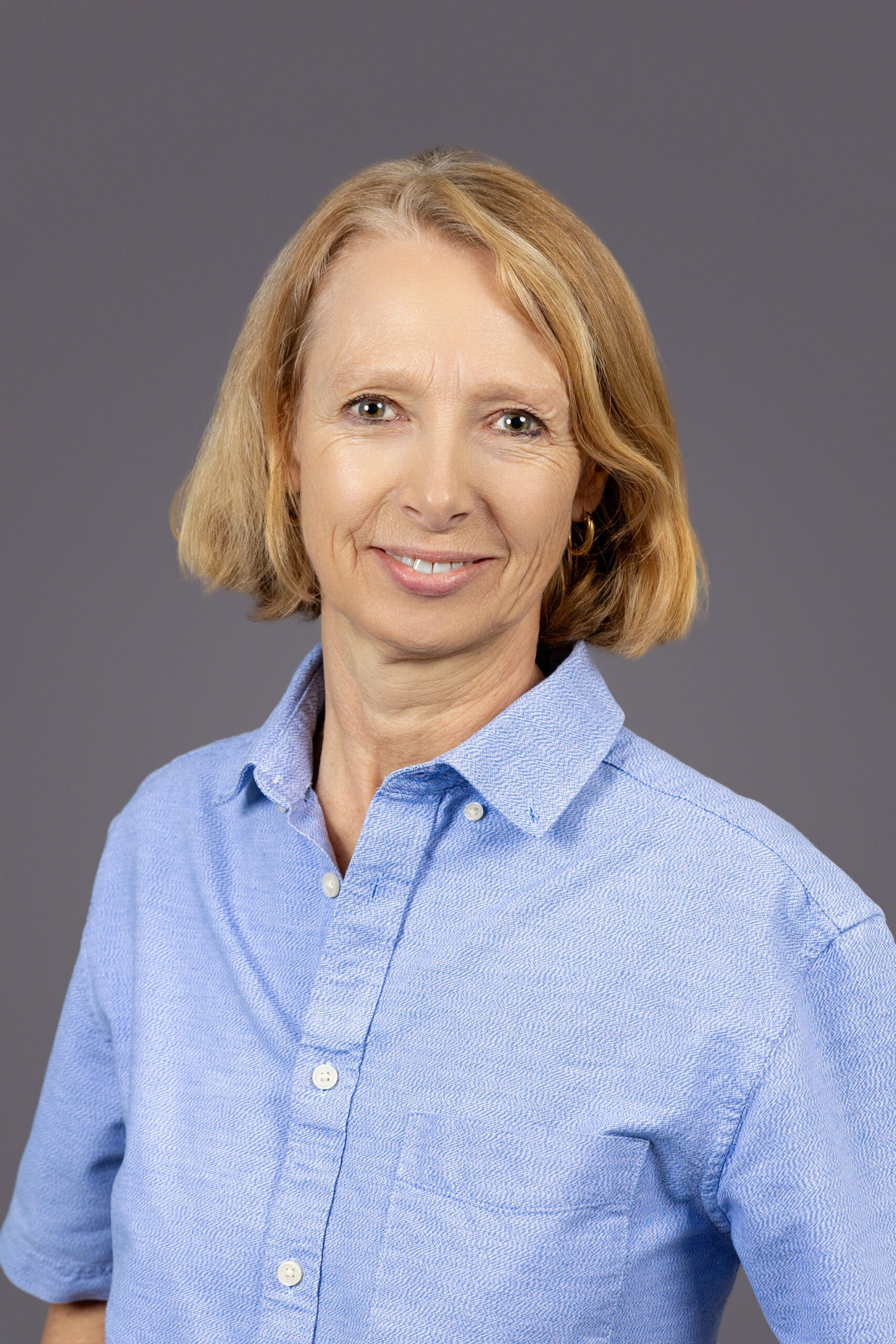 a woman in a blue shirt posing for a picture