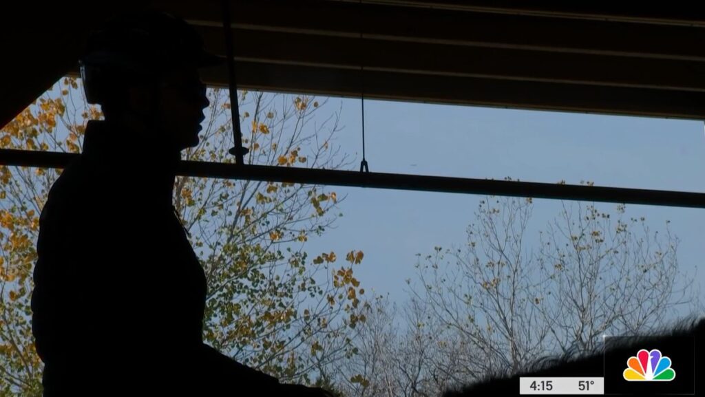 silhouette of a man standing in front of a window