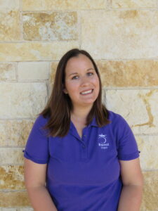 woman standing in front of a brick wall