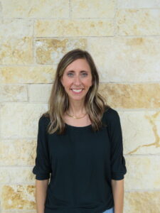 woman standing in front of a stone wall