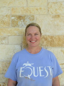 woman standing in front of a stone wall