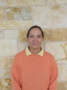 woman standing in front of a brick wall