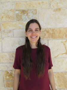 woman standing in front of a stone wall