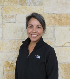 woman standing in front of a stone wall