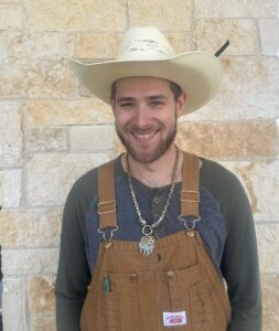 man wearing a cowboy hat and overalls