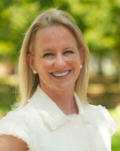 woman in a white dress smiling at the camera