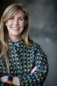 smiling woman with her arms crossed